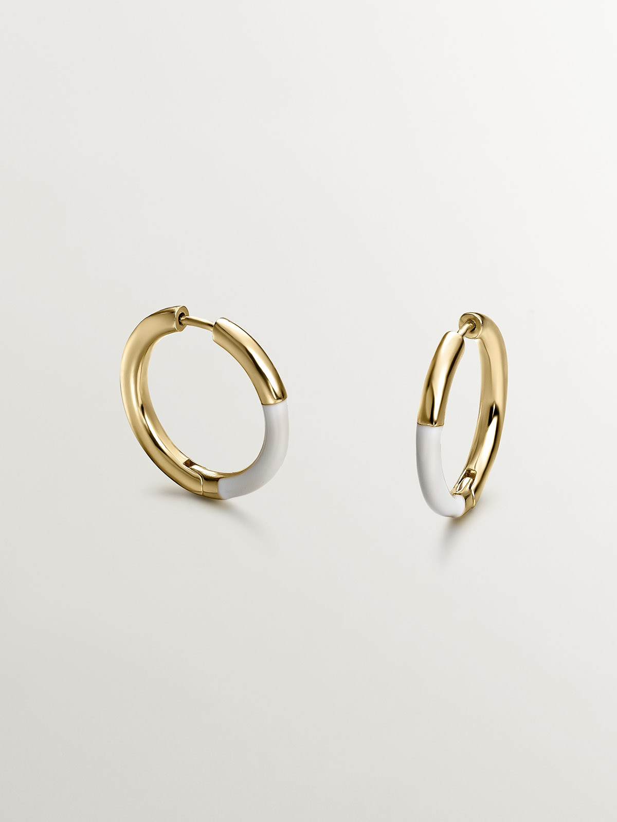 Medium hoop earrings made of 925 silver bathed in 18K yellow gold with white enamel