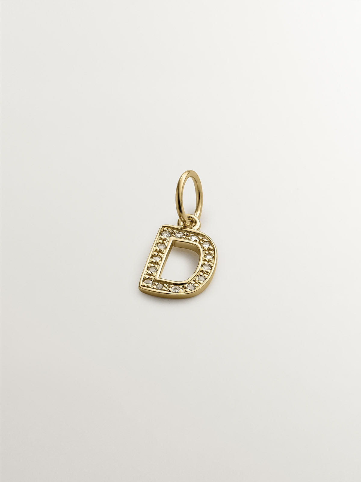 D initial charm made of 925 silver bathed in 18K yellow gold and white topaz.