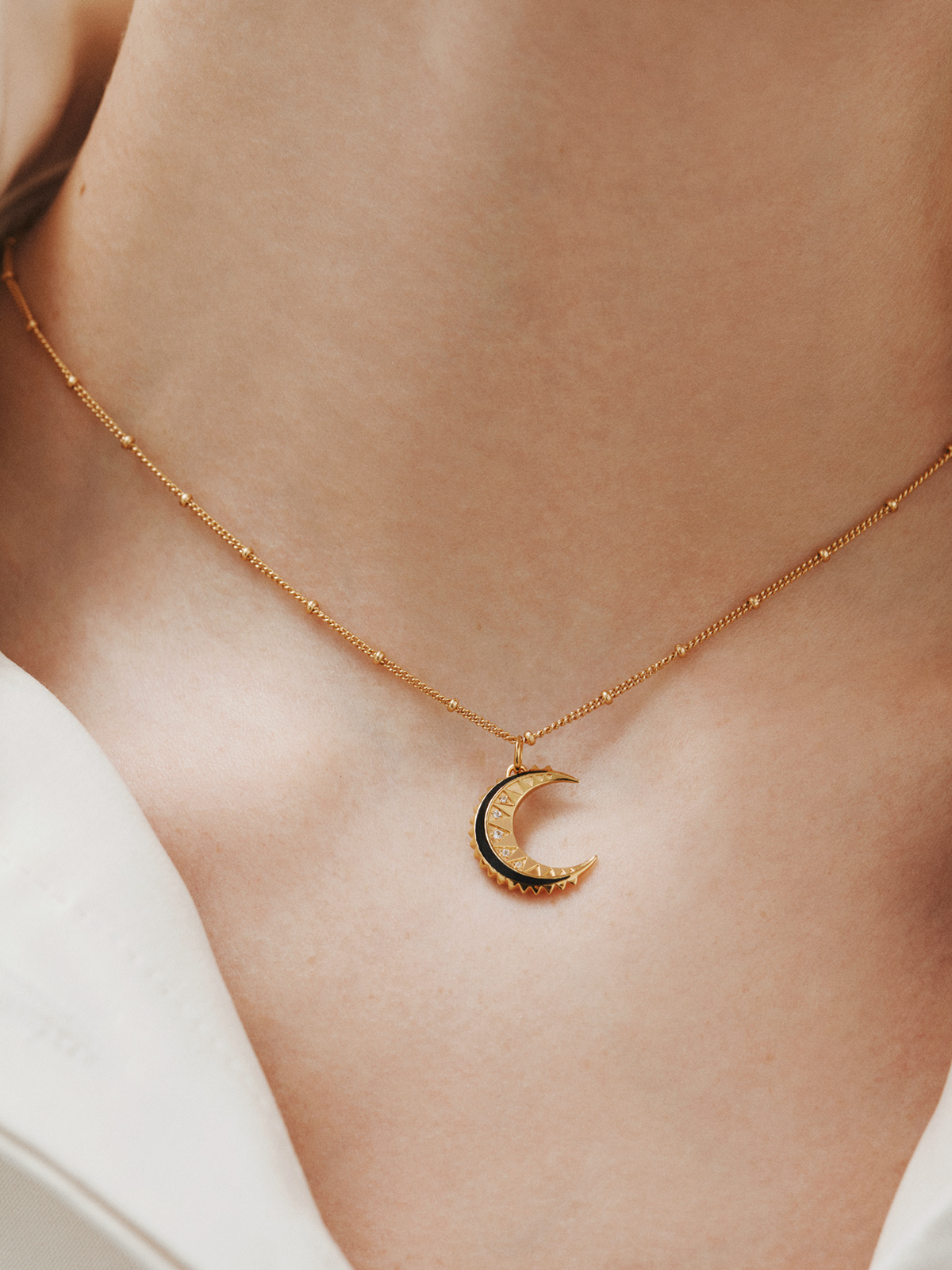 925 silver charm bathed in 18k yellow gold with white tapacios, black enamel and moon shape