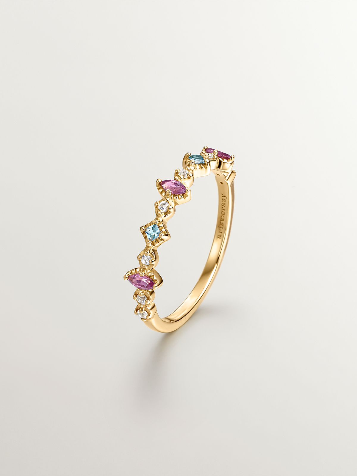 925 Silver ring bathed in 18K yellow gold with topaz and rhodolites.