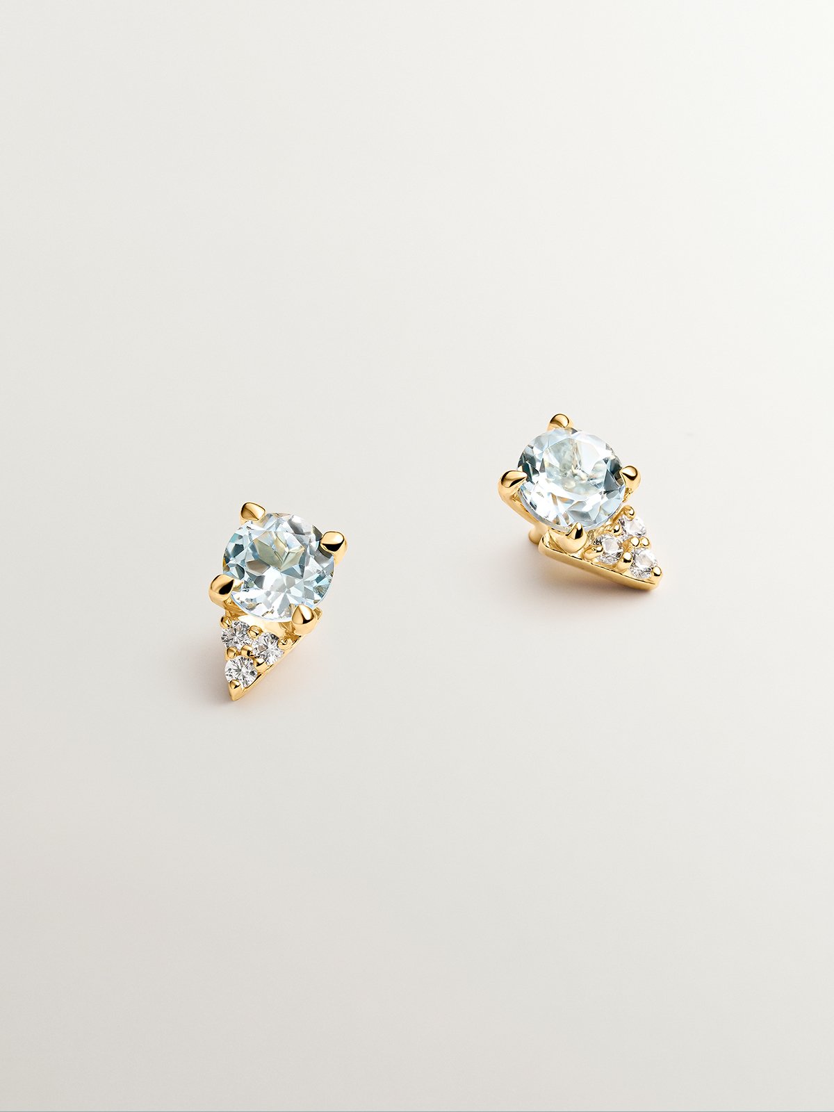 925 Silver earrings bathed in 18K yellow gold with sky blue topaz and white sapphires.